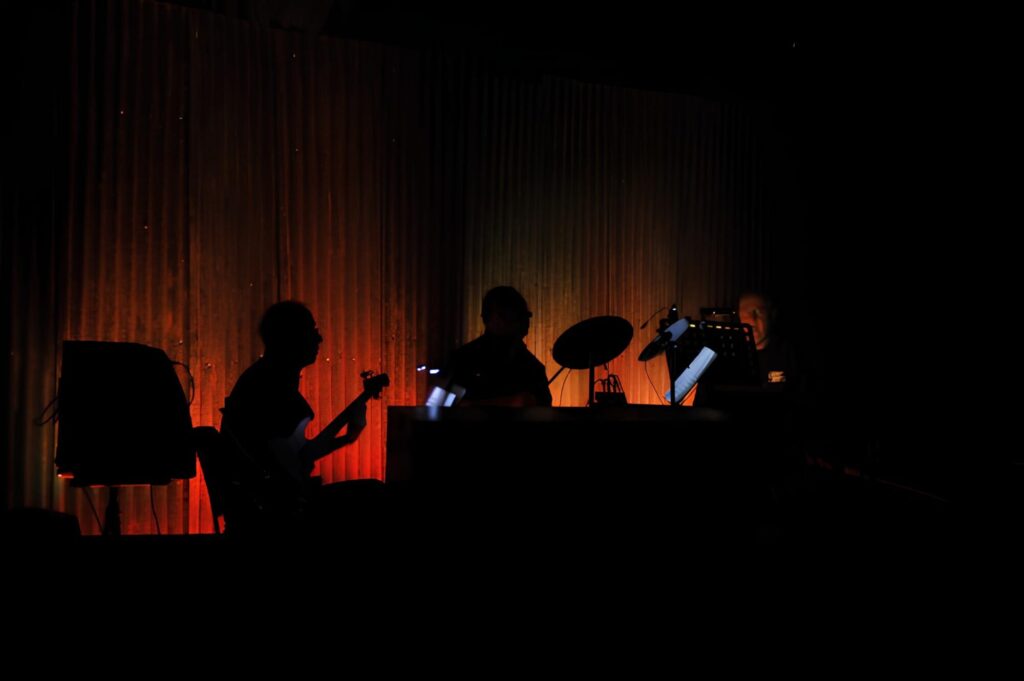Silhouetted theatre band performing with stage lighting – live event supported by JET event equipment hire