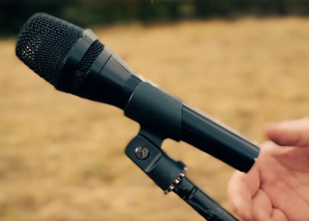 AKG P3 wired microphone mounted on stand during live outdoor event setup