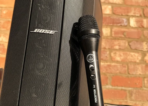 AKG microphone positioned next to Bose speaker for live announcements at event setup