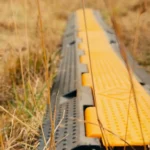 Cable protector ramp used outdoors to safely cover power and audio cables across walkways