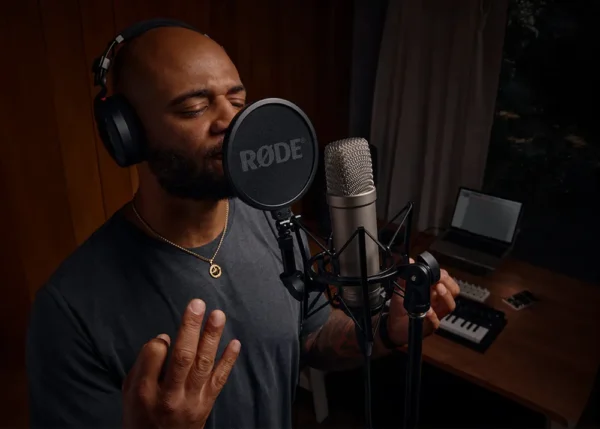 condenser microphone recording vocals in home studio setup