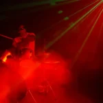 stage lighting with smoke machine creating dramatic light beams