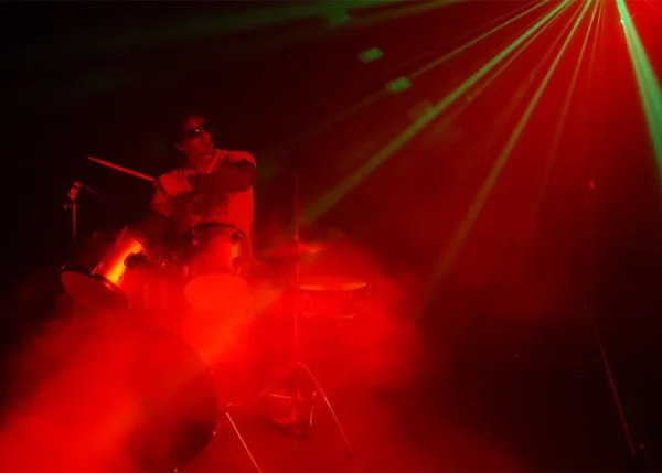 stage lighting with smoke machine creating dramatic light beams