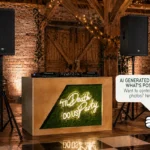 Rustic DJ booth with Till Death Do Us Party neon sign at a barn wedding setup