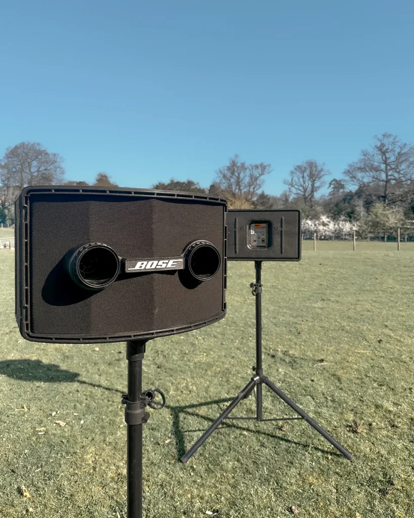 Bose outdoor PA speakers on stands set up in a field for event sound hire