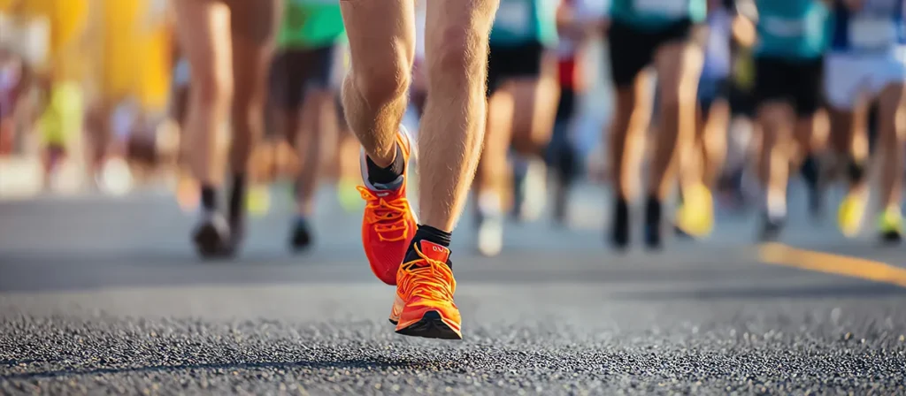 Close-up of runners taking part in an outdoor race or charity run event