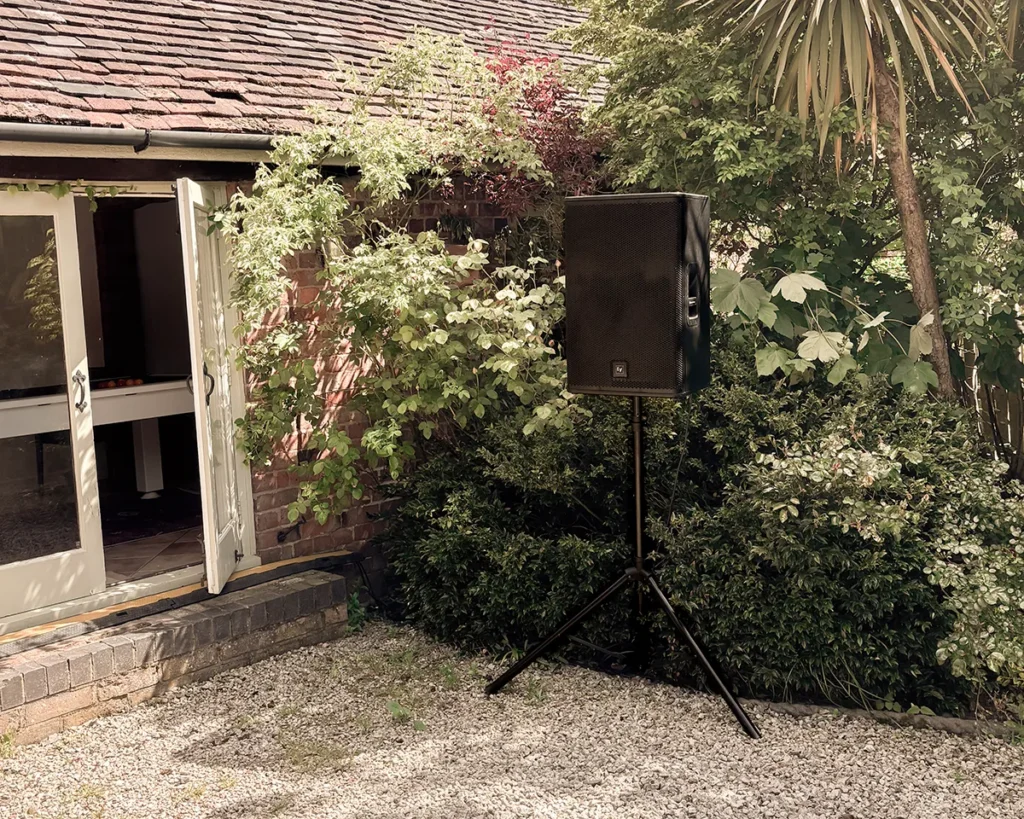 Outdoor PA speaker on stand set up in a garden for private event sound hire